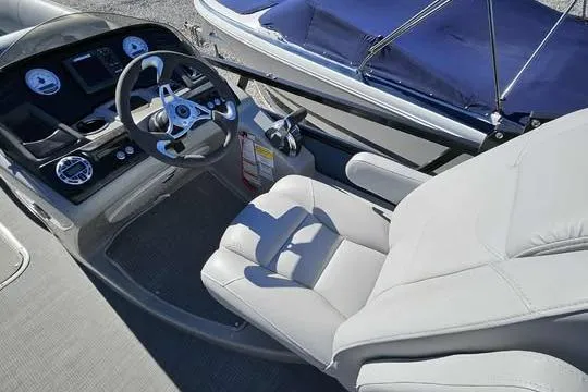 Slide: The Image of 2018 Regency 220 DL3 boat interior with steering wheel and comfortable seating. - 3