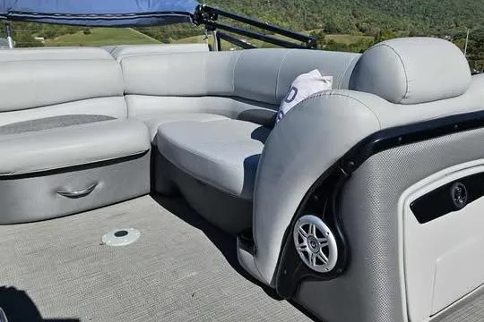 Slide: The Image of 2018 Regency 220 DL3 pontoon boat interior with gray seating and speaker. - 5
