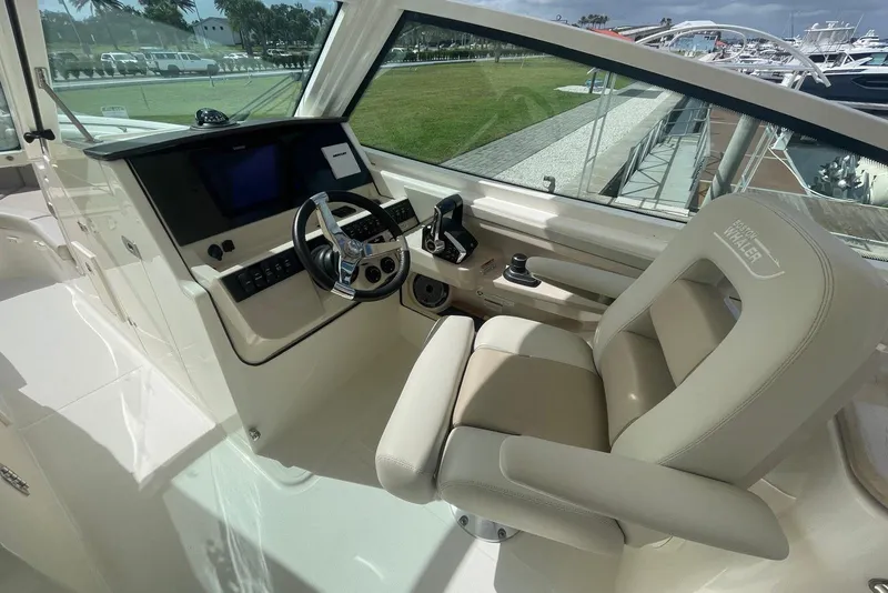 Slide: The Image of 2023 Boston Whaler 280 Vantage helm with modern controls and comfortable seating. - 11