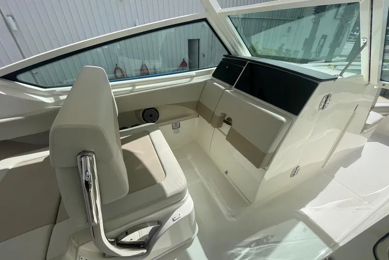 Slide: The Image of 2023 Boston Whaler 280 Vantage interior with beige seating and sleek design. - 14