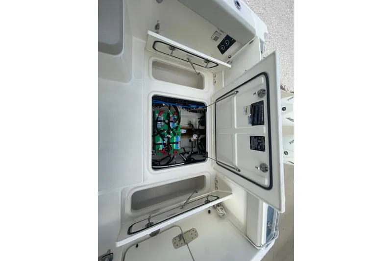 Slide: The Image of 2023 Boston Whaler 280 Vantage boat battery compartment with wiring and components. - 17