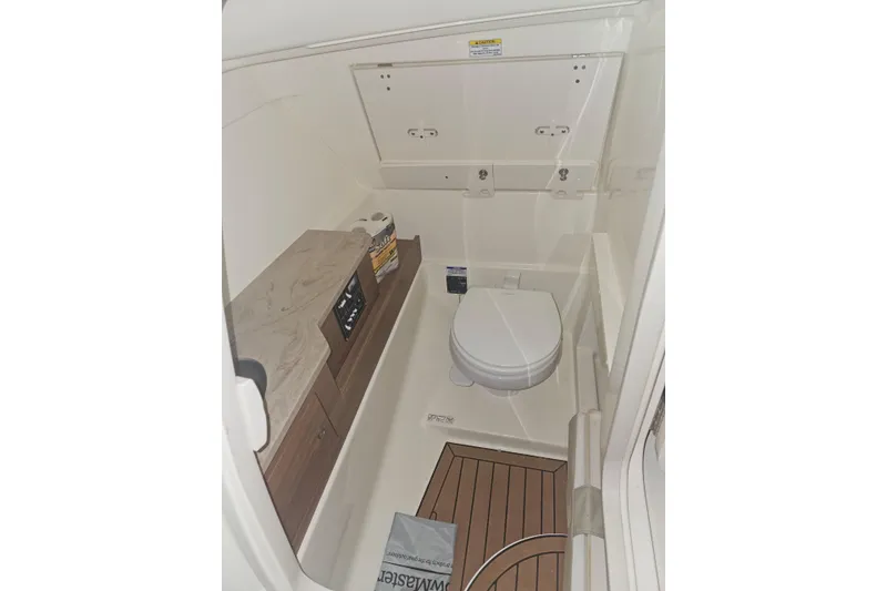Slide: The Image of 2023 Boston Whaler 280 Vantage boat interior bathroom with toilet and wooden flooring. - 20