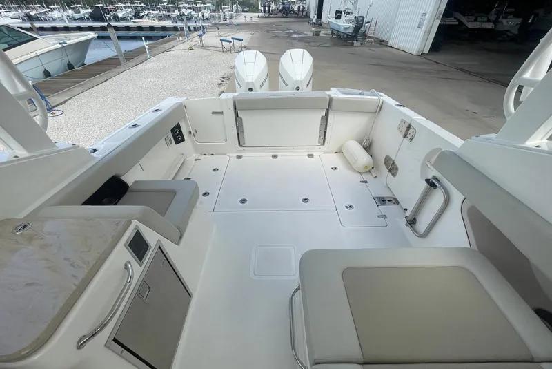 Slide: The Image of 2023 Boston Whaler 280 Vantage boat interior with seating and storage compartments. - 6