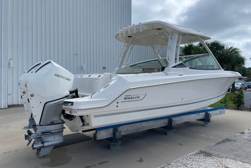 Slide: The Image of 2023 Boston Whaler 280 Vantage boat with Mercury engines, docked outdoors. - 7