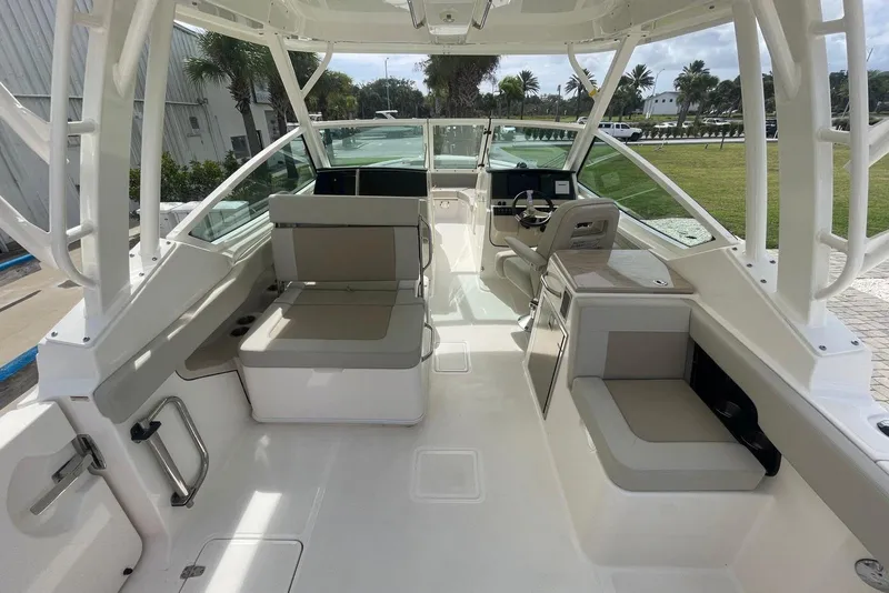 Slide: The Image of 2023 Boston Whaler 280 Vantage interior with seating and helm, showcasing modern design. - 8