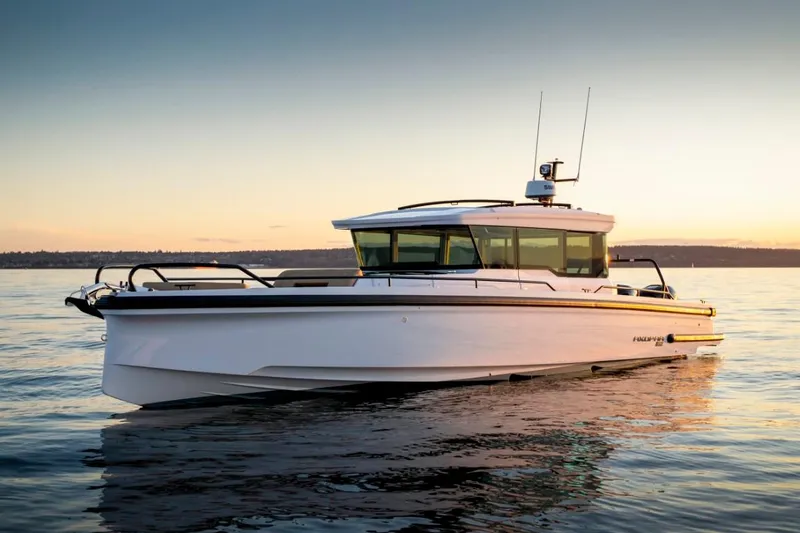 Slide: The Image of 2024 Axopar 37XC CROSS CABIN boat on calm water at sunset. - 11