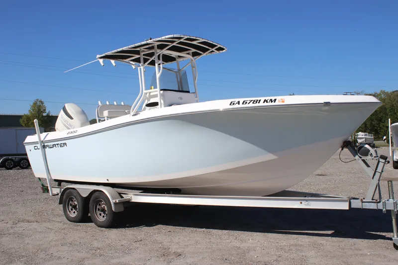 Slide: The Image of 2023 Clearwater boat on trailer, model 2300, parked outdoors under clear blue sky. - 1