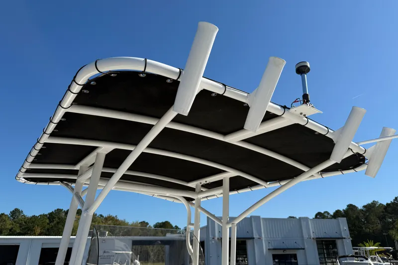 Slide: The Image of T-top of 2023 Clearwater boat with rod holders against clear blue sky. - 11