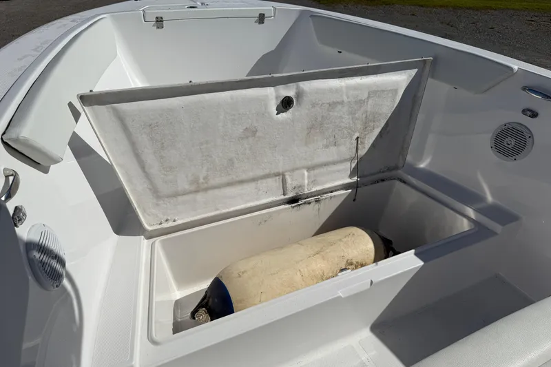 Slide: The Image of Open storage compartment on a 2023 Clearwater boat, revealing a fender inside. - 14