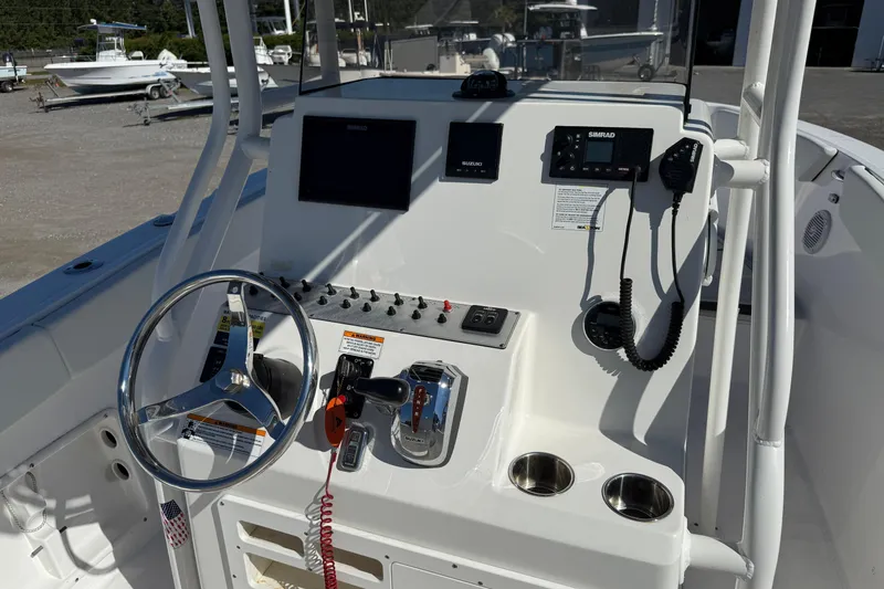 Slide: The Image of 2023 Clearwater boat console with steering wheel, controls, and navigation equipment. - 18