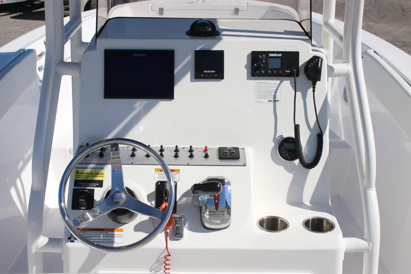 Slide: The Image of Control panel of a 2023 Clearwater boat featuring steering wheel, gauges, and communication devices. - 4