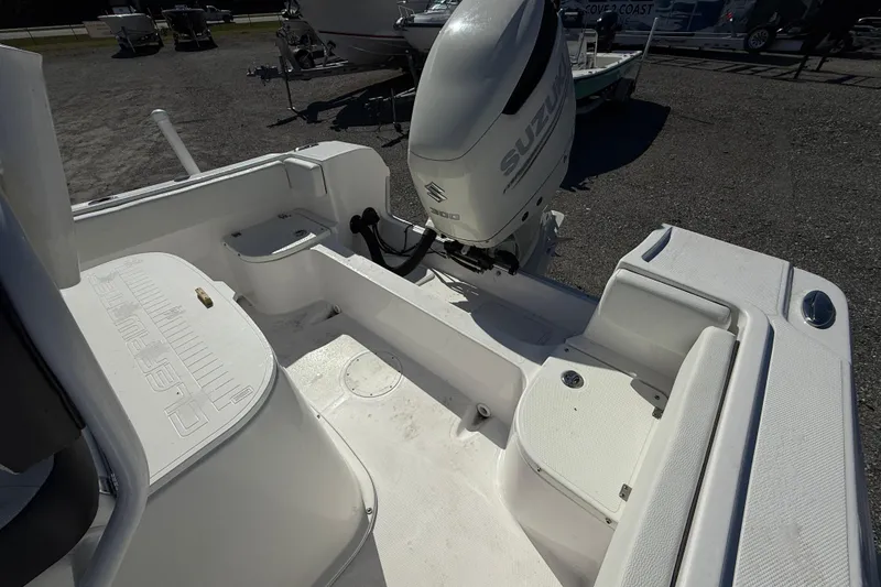 Slide: The Image of 2023 Clearwater boat with Suzuki outboard motor, white interior, and spacious seating area. - 9