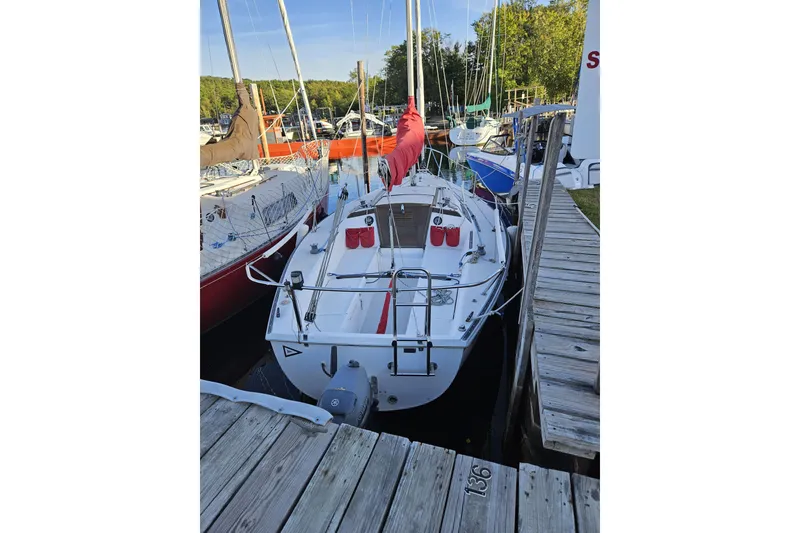 Slide: The Image of 1981 Catalina Capri 25 sailboat docked at marina, surrounded by other boats. - 2