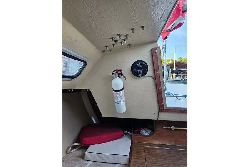 Slide: The Image of Interior of 1981 Catalina Capri 25 sailboat with fire extinguisher and window view. - 4