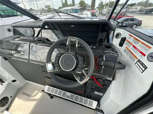 Slide: The Image of 2024 BRABUS Shadow 1000 ST boat cockpit with sleek steering wheel and modern controls. - 13