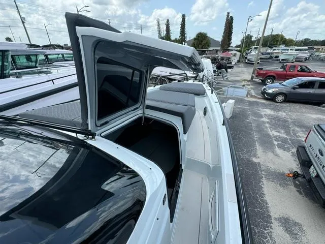 Slide: The Image of 2024 BRABUS Shadow 1000 ST luxury boat with open cabin, docked in a marina. - 18