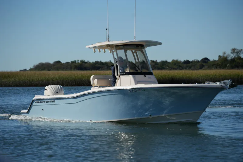 Slide: The Image of 2024 Grady-White Fisherman 236 boat cruising on calm water. - 0