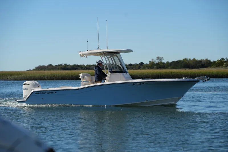 Slide: The Image of 2024 Grady-White Fisherman 236 boat cruising on a calm waterway. - 1