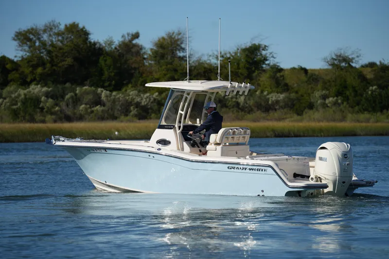 Slide: The Image of 2024 Grady-White Fisherman 236 boat cruising on a serene waterway. - 10