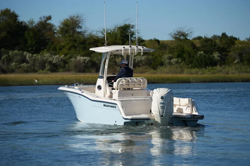 Slide: The Image of 2024 Grady-White Fisherman 236 boat cruising on a serene lake. - 11