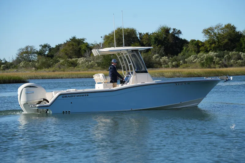 Slide: The Image of 2024 Grady-White Fisherman 236 boat cruising on calm water, side view. - 13