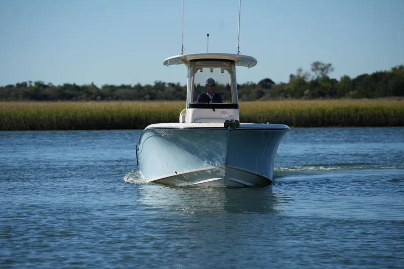 Slide: The Image of 2024 Grady-White Fisherman 236 boat cruising on calm water. - 14