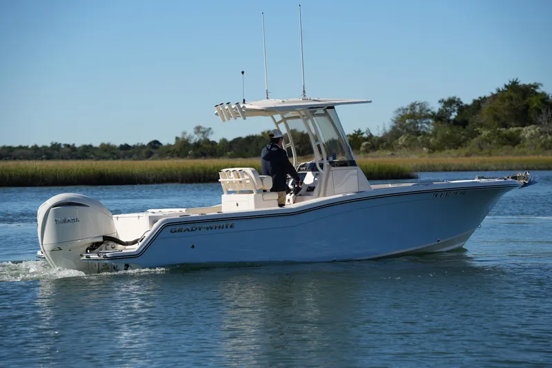 Slide: The Image of 2024 Grady-White Fisherman 236 boat cruising on calm water. - 16