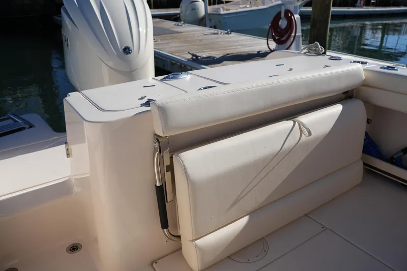Slide: The Image of 2024 Grady-White Fisherman 236 boat interior with cushioned seating and motor. - 19