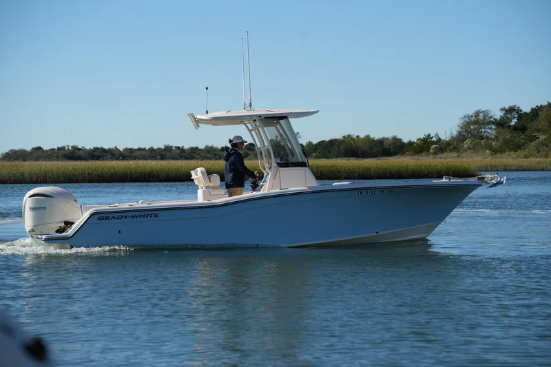 Slide: The Image of 2024 Grady-White Fisherman 236 boat cruising on calm water. - 2