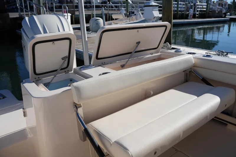 Slide: The Image of 2024 Grady-White Fisherman 236 boat interior with open storage compartments at dock. - 20