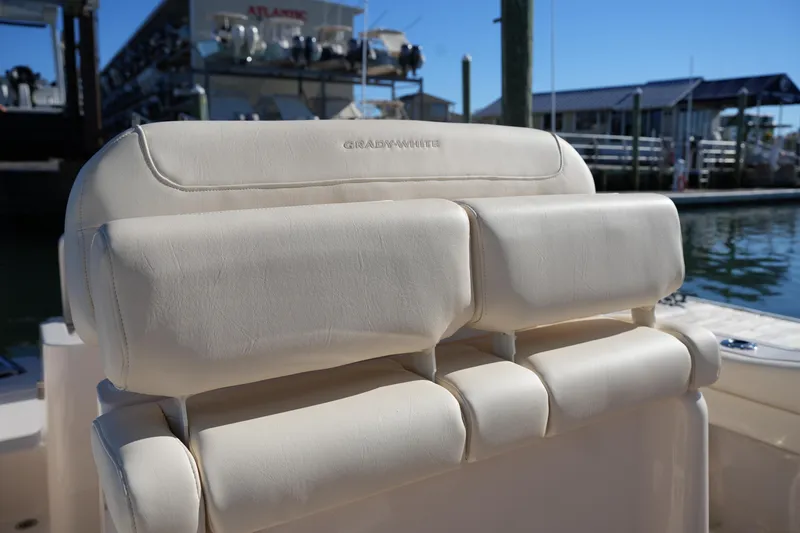 Slide: The Image of 2024 Grady-White Fisherman 236 boat seat, cream leather, dockside view. - 22