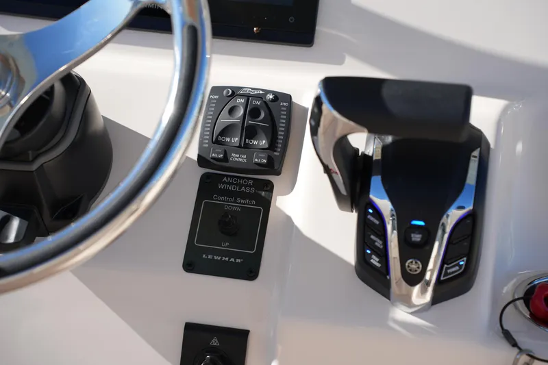 Slide: The Image of 2024 Grady-White Fisherman 236 helm controls with steering wheel and throttle. - 29
