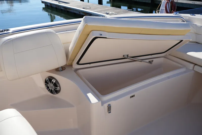 Slide: The Image of 2024 Grady-White Fisherman 236 boat with open storage compartment and cushioned seating. - 38