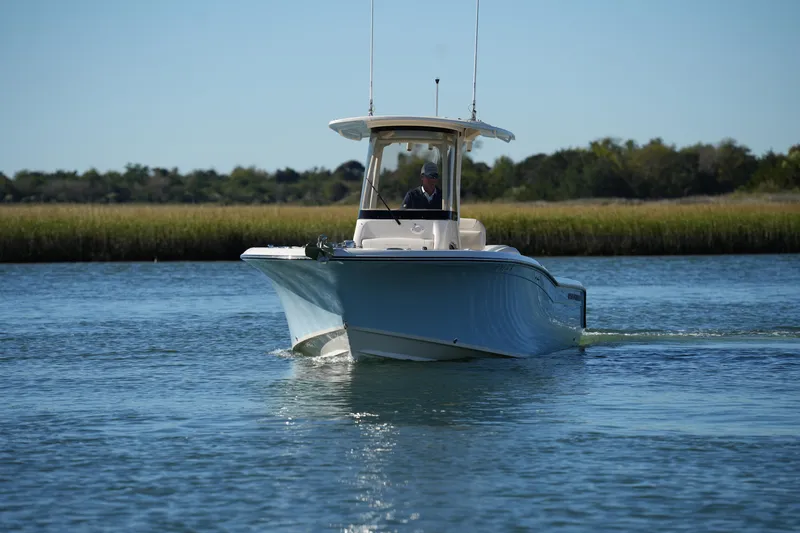 Slide: The Image of 2024 Grady-White Fisherman 236 boat cruising on a calm waterway. - 4