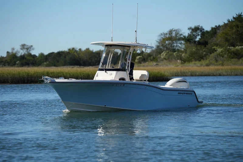 Slide: The Image of 2024 Grady-White Fisherman 236 boat cruising on a serene waterway. - 6