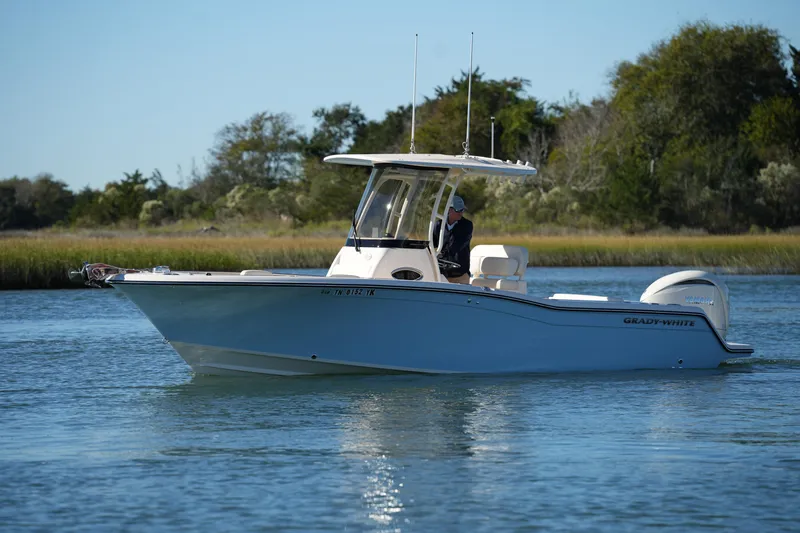 Slide: The Image of 2024 Grady-White Fisherman 236 boat cruising on a serene waterway. - 7