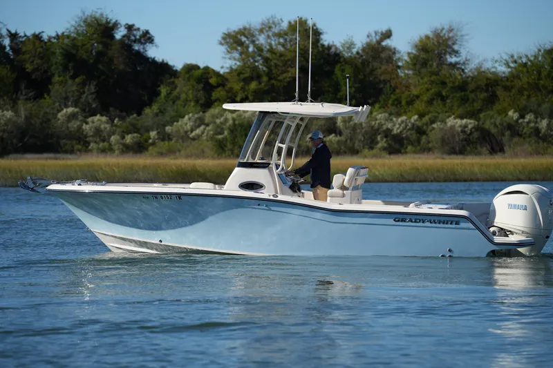 Slide: The Image of 2024 Grady-White Fisherman 236 boat cruising on a calm waterway. - 9