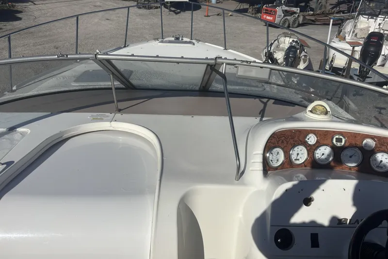 Slide: The Image of 2000 Larson Cabrio 330 Mid Cabin boat dashboard with gauges and steering wheel. - 19