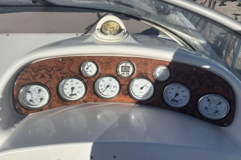 Slide: The Image of Dashboard of a 2000 Larson Cabrio 330 Mid Cabin boat with gauges and compass. - 20