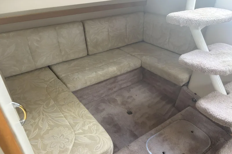 Slide: The Image of Interior of 2000 Larson Cabrio 330 Mid Cabin with beige seating and carpeted steps. - 21