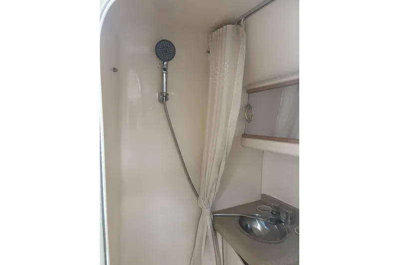 Slide: The Image of Shower and sink area in 2000 Larson Cabrio 330 Mid Cabin boat. - 32