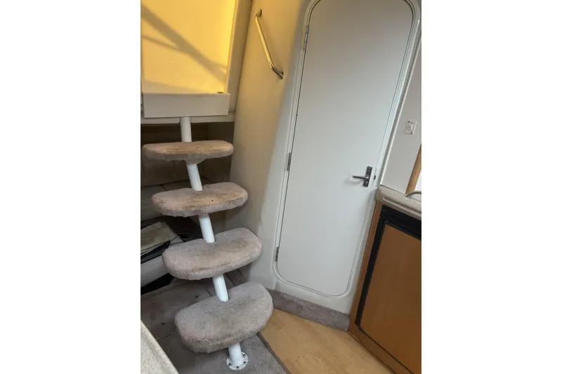 Slide: The Image of Interior of 2000 Larson Cabrio 330 Mid Cabin with carpeted steps and door. - 34