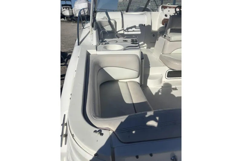 Slide: The Image of 2000 Larson Cabrio 330 Mid Cabin boat interior with white seating and helm. - 4
