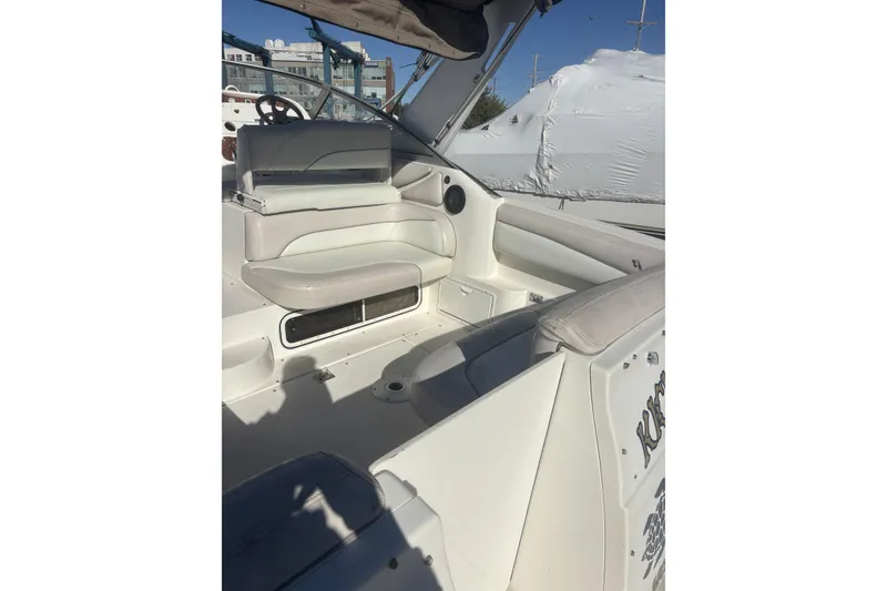Slide: The Image of 2000 Larson Cabrio 330 Mid Cabin boat interior with white seating and helm. - 5