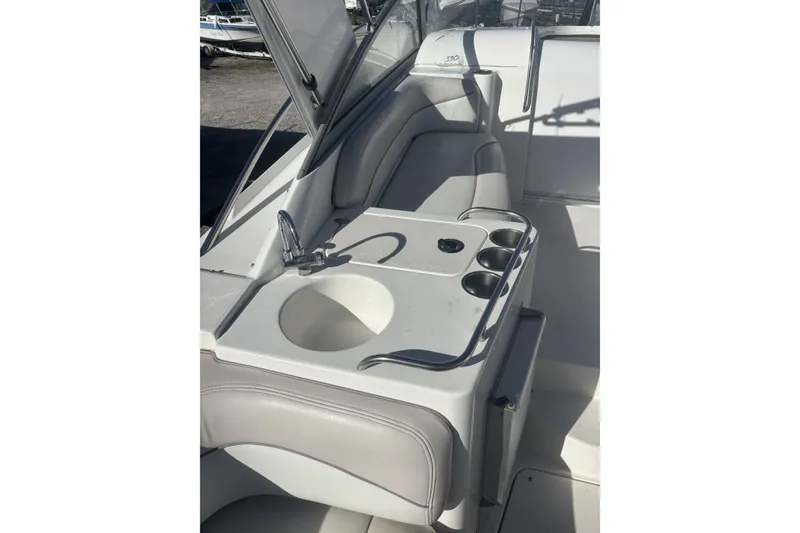 Slide: The Image of 2000 Larson Cabrio 330 Mid Cabin boat interior with sink and cup holders. - 7