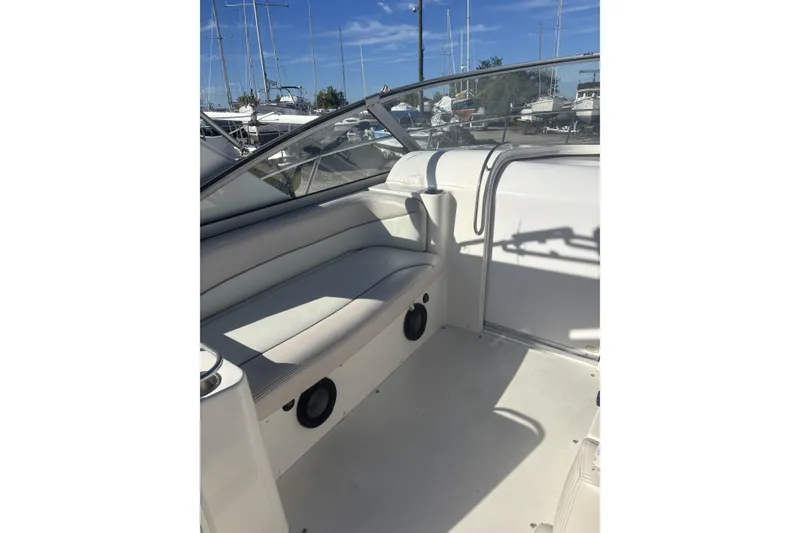 Slide: The Image of 2000 Larson Cabrio 330 Mid Cabin boat interior with seating and speakers. - 8