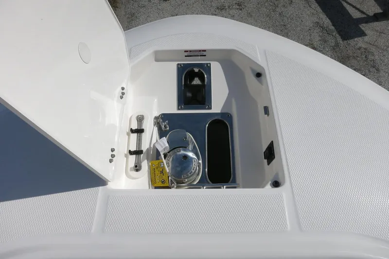 Slide: The Image of 2025 Robalo R250 Center Console anchor storage compartment with open hatch. - 14