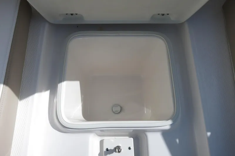 Slide: The Image of 2025 Robalo R250 Center Console boat storage compartment, open and empty. - 15