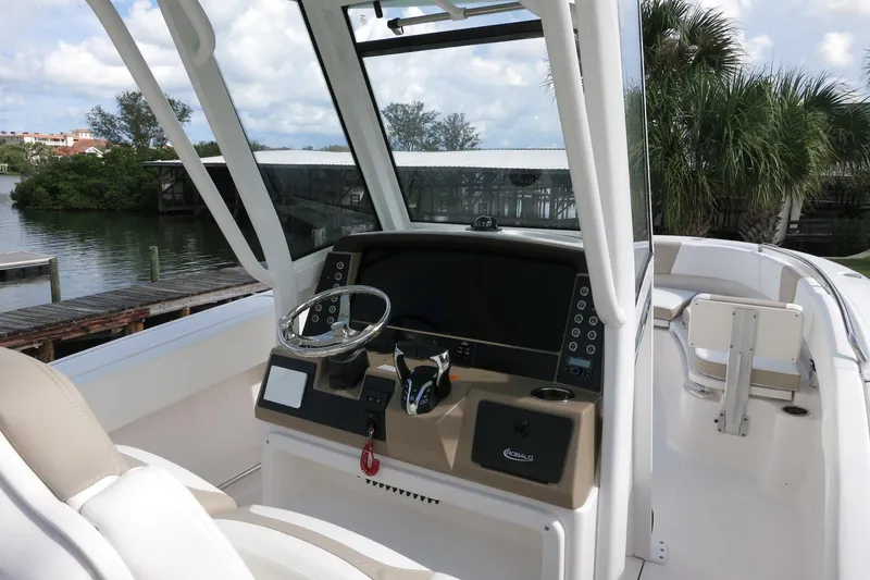Slide: The Image of 2025 Robalo R250 Center Console boat interior with steering wheel and dashboard. - 22