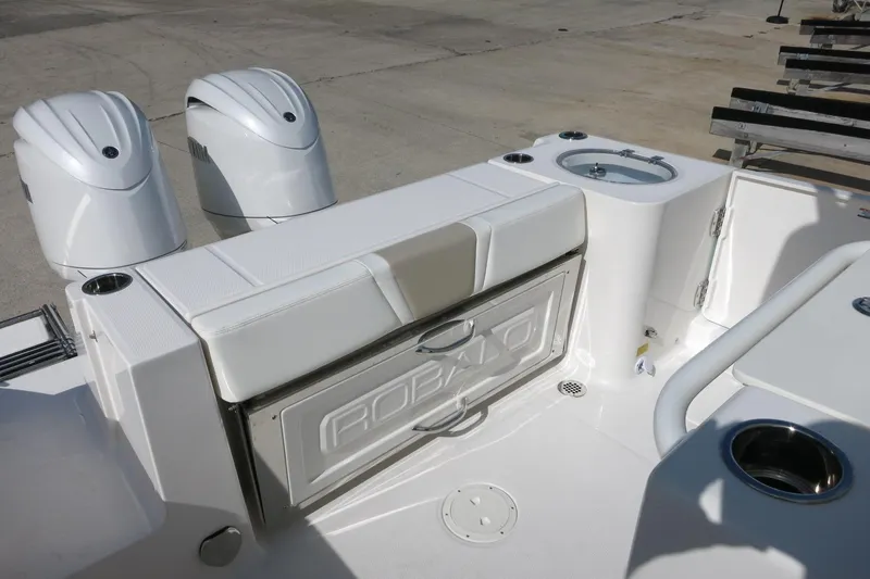 Slide: The Image of 2025 Robalo R250 Center Console boat with dual engines and sleek white seating. - 24